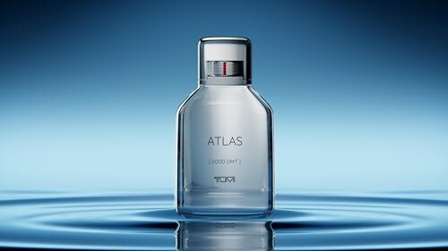 Atlas perfume bottle on a rippled water surface with blue background.