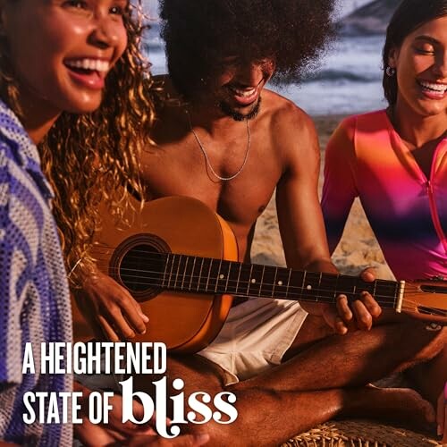 Friends enjoying music on the beach with a guitar.