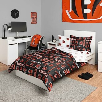 Bedroom with Cincinnati Bengals decor, including bedding, flag, and backpack.