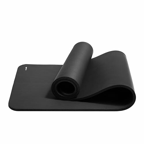Black rolled up yoga mat with carrying strap
