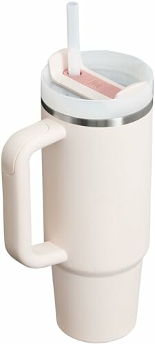 Cream-colored tumbler with handle and straw