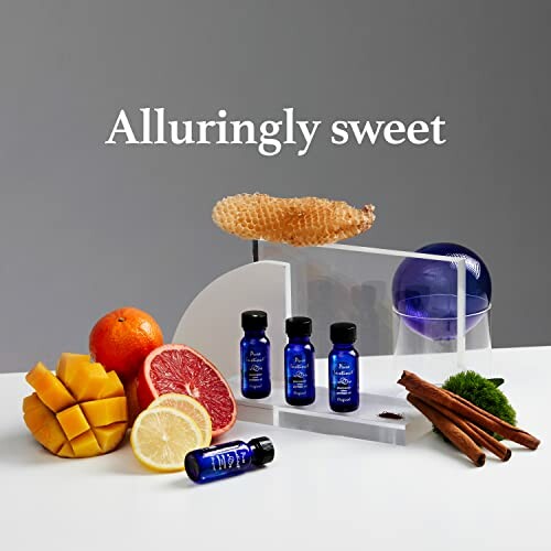 Fruits, cinnamon, and essential oils with honeycomb display.