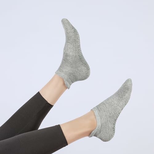 Person wearing gray socks with legs raised.