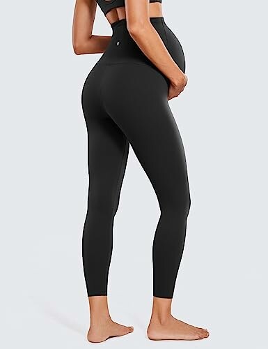 Pregnant woman wearing black maternity leggings