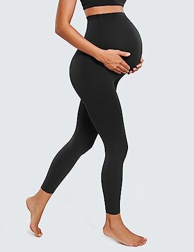 Pregnant woman wearing black maternity leggings