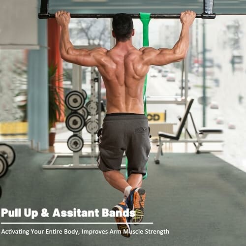 Man doing pull-up with assistant bands in a gym.