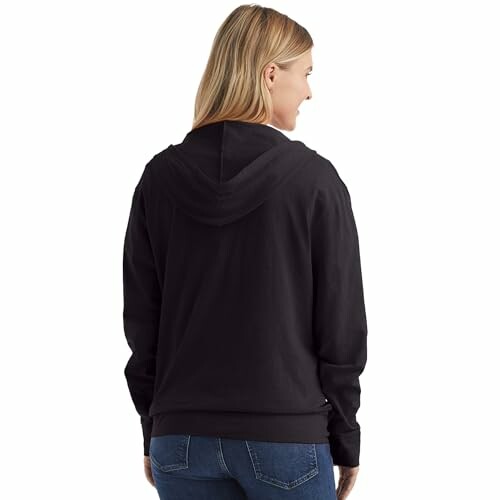 Woman wearing a black hoodie, viewed from the back.