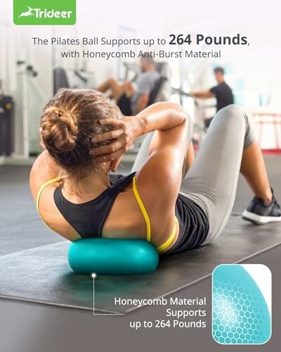 Woman exercising on a Pilates ball in a gym.