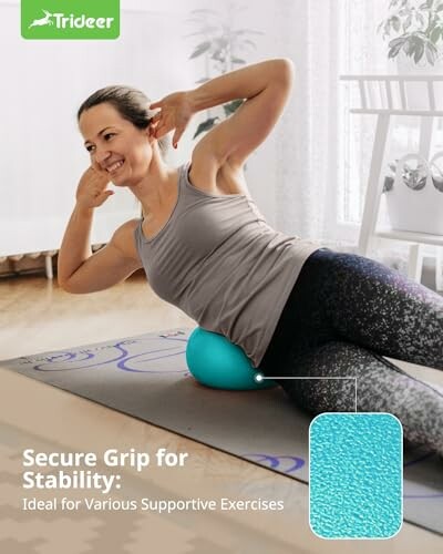 Woman using a stability ball for exercise on a yoga mat.