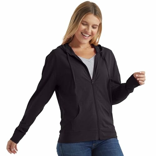 Smiling woman in black zip-up hoodie