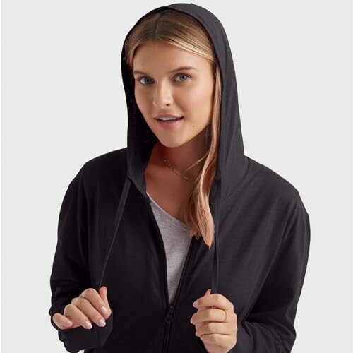 Woman wearing a black hoodie.